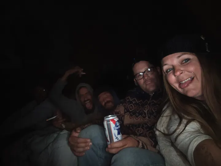 Guests taking a group photo together at night.